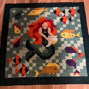 Colorful Handmade Mermaid Quilt measures 40” by 40”.